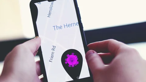 Contact tracing app background with hand scrolling covid sick map on smartphone Stock Footage 128691409