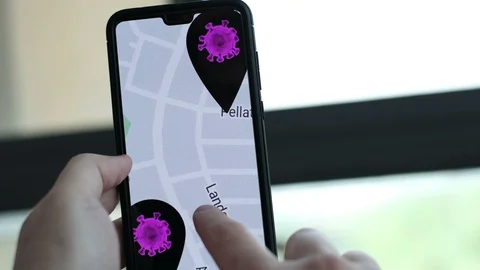 Contact tracing app background with hand zooming on virus symbol Stock Footage 128691751