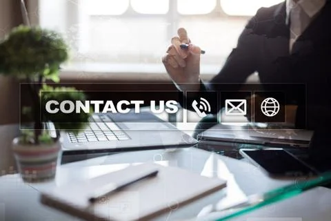 Contact us button and text on virtual screen. Business and technology concept. Stock Photos
