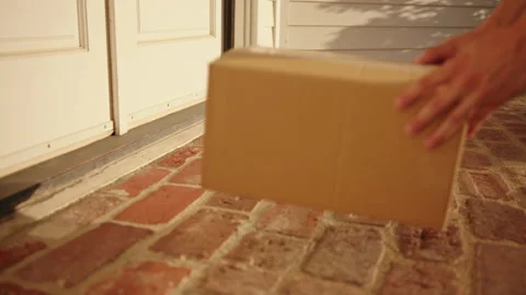 Contactless delivery of a parcel to a doorstep Stock Footage 130298611
