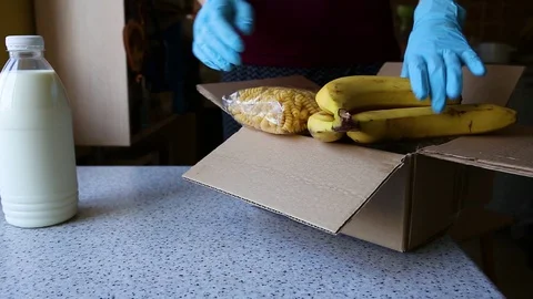 Contactless delivery services. A customer unpacks an order from an online store. Stock Footage 129727174