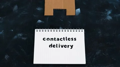 Contactless Delivery text on notepad with house icon, groceries shopping duri Stock Footage 136138878