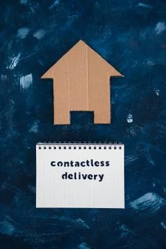 Contactless Delivery text on notepad with house icon concept of shopping duri Stock Photos