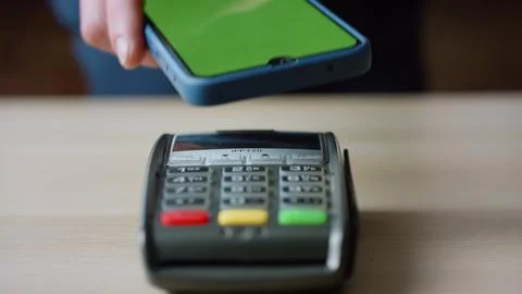 Contactless pay using phone with chroma key screen at bank pos terminal close up Stock Photos