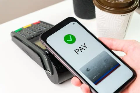 Contactless payment for coffee using application in smartphone. Stock Photos