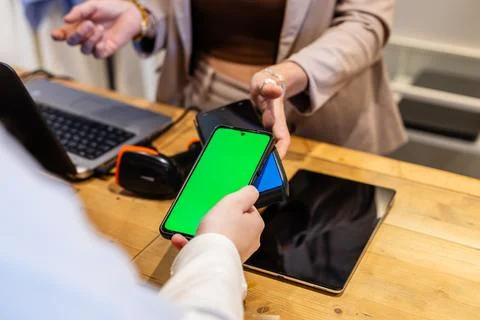 Contactless payment using smartphone with green screen at checkout Fotos Stock