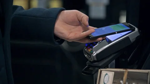 Contactless payment with your smartphone. Paying with a smartphone device on a Stock Footage 61517865