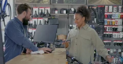 Contactless Purchase using Smart phone in Bicycle Store Stock Footage 250631117