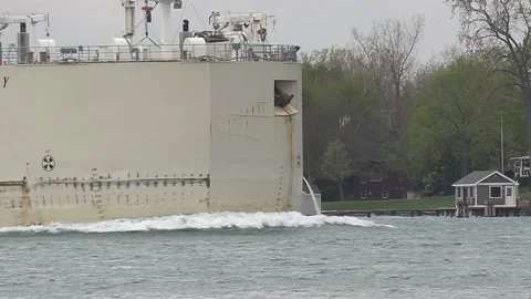 Container and cargo ship heading up river to oil refinery in Sarnia Stock Footage 153827215