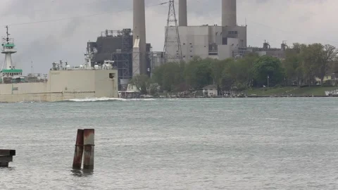 Container and cargo ship heading up river to oil refinery in Sarnia Stock-Footage 153828030