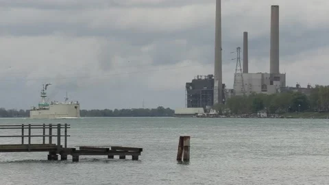 Container and cargo ship heading up river to oil refinery in Sarnia Stock-Footage 153828729