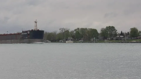 Container and cargo ship heading up river to oil refinery in Sarnia Stockbeeldmateriaal 153922564