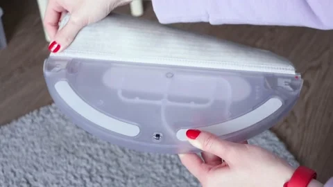 Container and rag for wet cleaning from a vacuum cleaner robot. Stock Footage 218012806