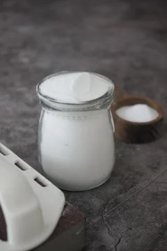 Container with baking soda powder on a table Stock Photos
