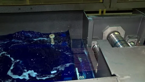 A container with a blue liquid for copper-plating wire. Stock Footage 118043308