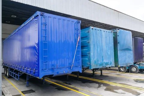 Container box docked at warehouse to load and unload goods for delivery Stock Photos