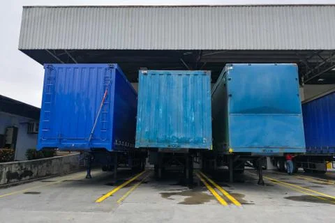 Container box docked at warehouse to load and unload goods for delivery Stock Photos