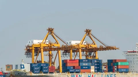 Container Cargo freight ship with working crane bridge for export and import in  Stock-Footage 97929187