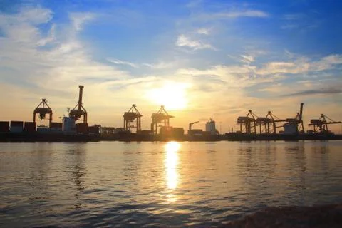 Container cargo freight ship with working crane bridge 스톡 사진