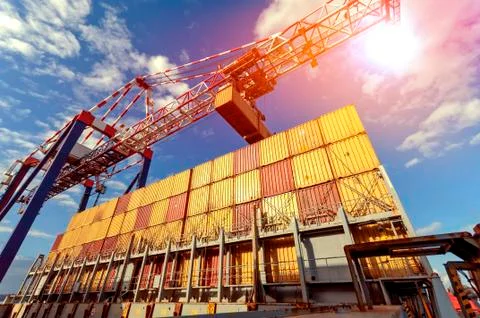 Container Cargo freight ship with working crane bridge during port operations Stock Photos