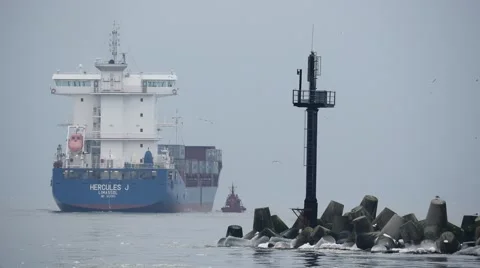 Container cargo ship go from port to open sea in foggy weather  4k Stock Footage 46145473