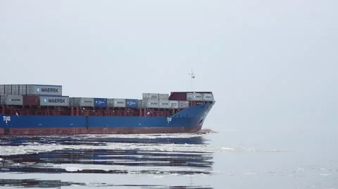 Container cargo ship go from winter port waters in foggy weather  4k Stock Footage 46144958