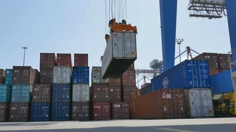 Container cargo ship loading / unloading by gantry crane 4k creative business vi Stock Footage 141911336