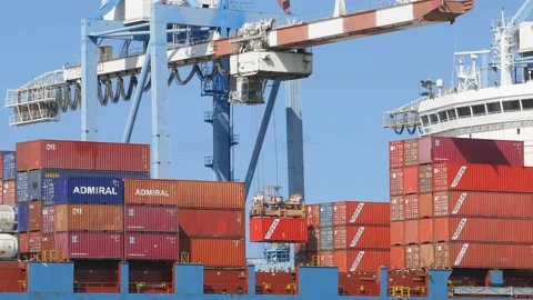 Container cargo ship loading / unloading by gantry crane 4k creative business vi Stock Footage 141912281