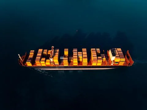 Container Cargo Ship Navigating Calm Ocean Waters At Golden Hour High Angle.. 스톡 사진