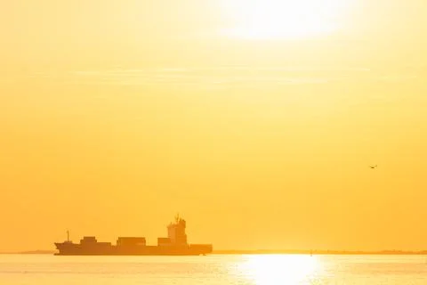 Container cargo ship in the ocean at sunset sky background at Bangpoo, Samutp Stock Photos