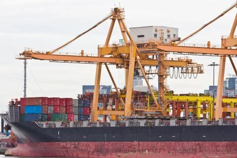Container cargo with working crane in shipyard Stock Photos