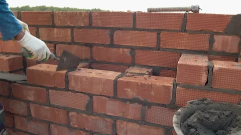 Container with cement mortar and part of the brick wall close-up. Residential Stock Footage 157257403