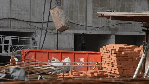 Container with cement mortar is lifted by a crane, to a construction site Stock Footage 172224921