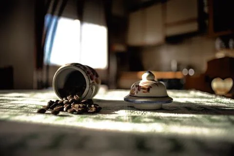 Container of coffee beans poured on the table  Stock Photos