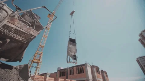 Container with a concrete moving down with a construction crane Stock Footage 142859538