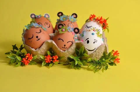 The container contains Easter eggs with cute faces. Spring. Easter. Stock Photos
