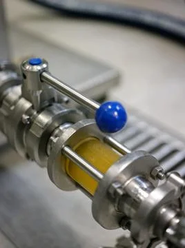 Container with craft beer inside in a canning factory Stock Photos