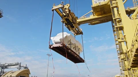 Container crane lifting oversized cargo at shipping dock. Stock Footage 334250598