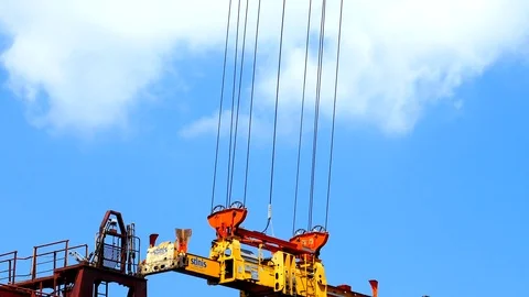 Container crane spreader with blue sky background 4k intro video for business Stock Footage 96322965
