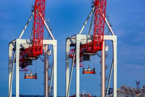 Container cranes at shipyard big heavy technique for unloading containers. Stock Photos
