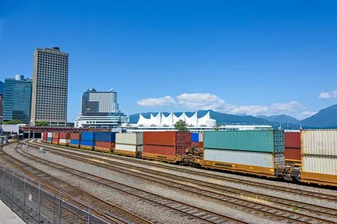Container double cargo train going via downtown of Vancouver Stockfoto's