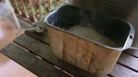 Container with dough put into baking machine Stock Footage 48120445