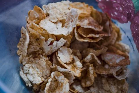 A container of emping crackers to be used as toppings for soto Stock Photos