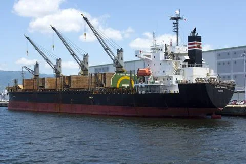 Container freight ship at dock in port. Stock Photos