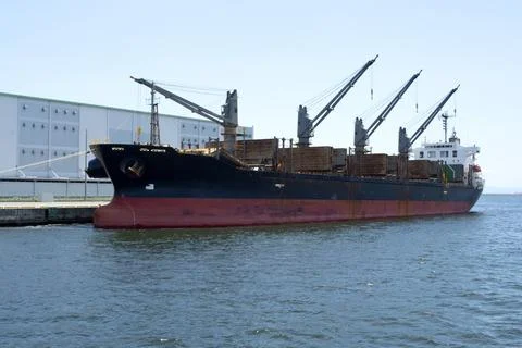 Container freight ship at dock in port. Stock Photos