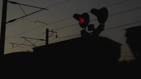 Container freight train passes through railway level crossing with blinking Stock Footage 117419507