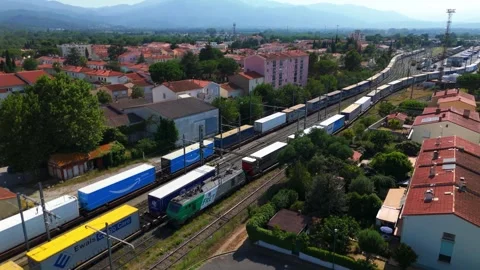 Container Freight Train Passing Through Urban Rail Corridor Aerial Pullback Stock Footage 336777277