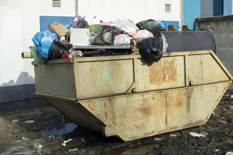 Container with garbage. Place for waste. Garbage can in city. Stock Photos