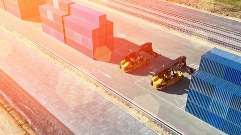 Container handler forklift lifting in shipping yard with stack of colorful 스톡 사진