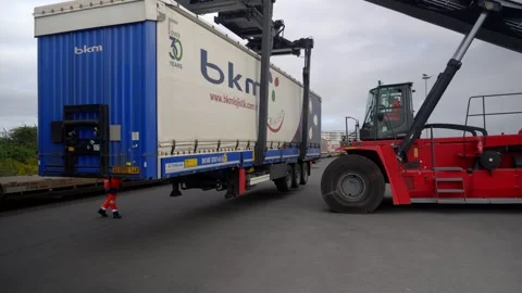 Container Handler Loading Cargo Trailer onto Train Wagon at Le Havre Freight Stock Footage 337976169